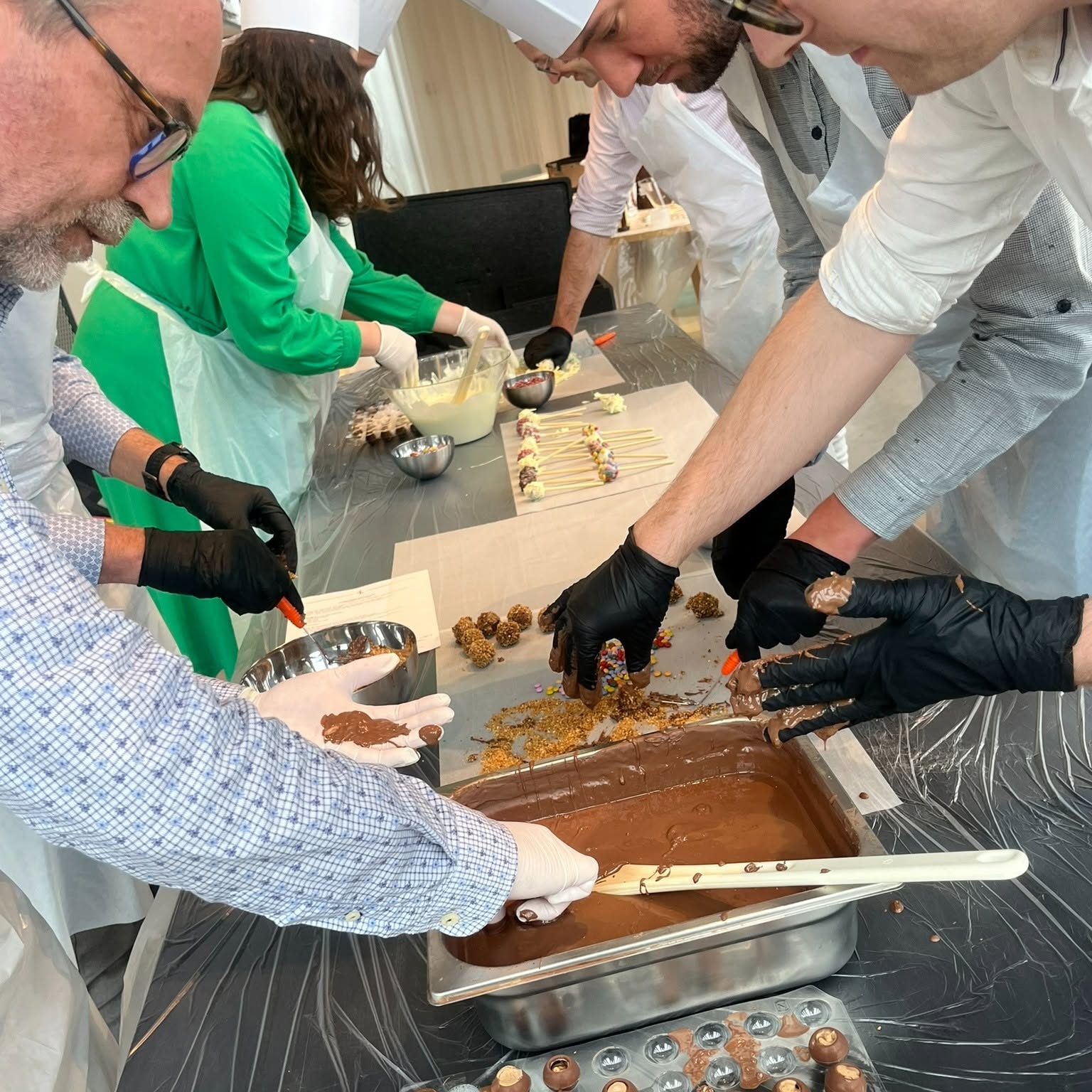 Handmade chocolate truffles being finished in a workshop.